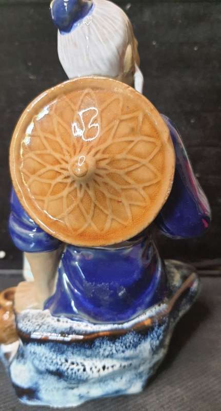 A VINTAGE JAPANESE MUD MAN FIGURINE SOLD AS IS