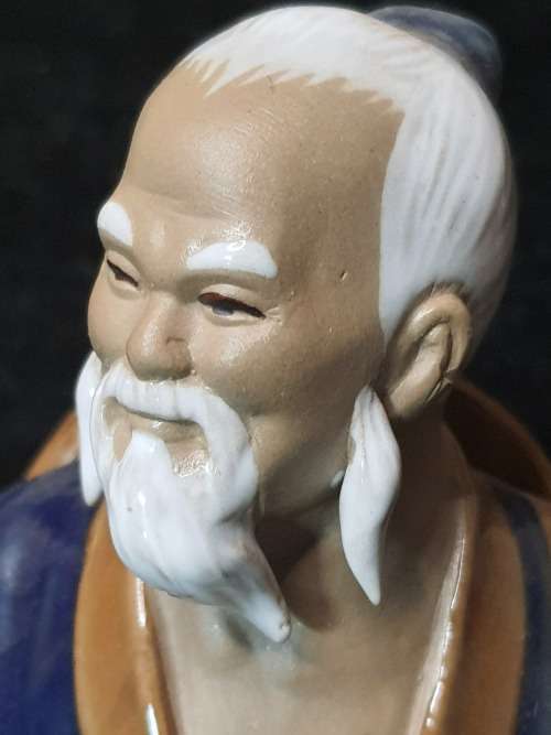A VINTAGE JAPANESE MUD MAN FIGURINE SOLD AS IS