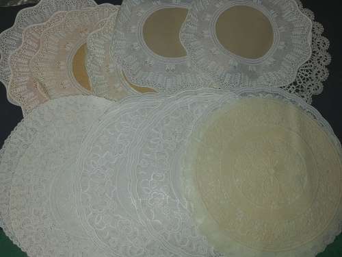 A vintage job lot cotton and Poly plastic doilies and coasters sold as is