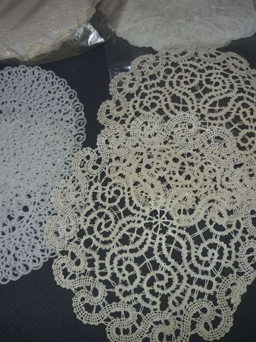 A vintage job lot cotton and Poly plastic doilies and coasters sold as is