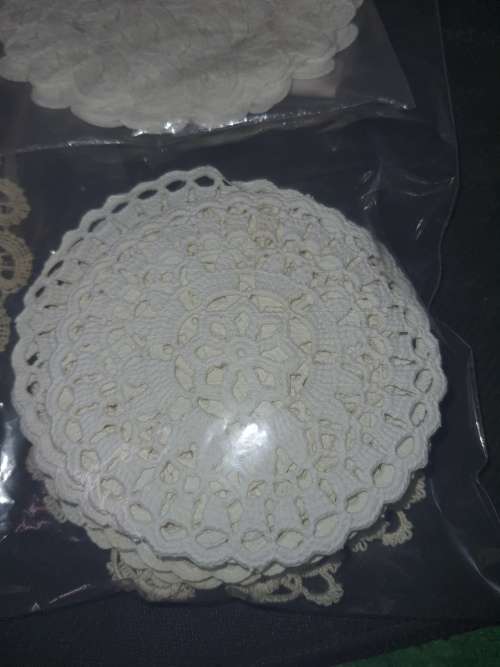 A vintage job lot cotton and Poly plastic doilies and coasters sold as is