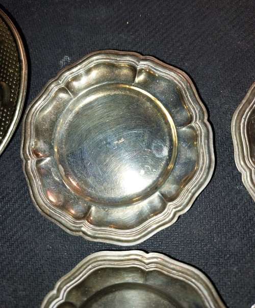 A collection of vintage utensils and a pair of silver-plated candle holders in good condition sold a