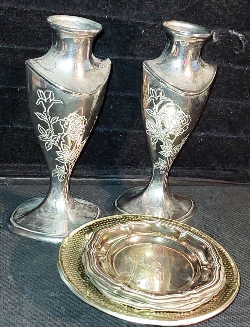 A collection of vintage utensils and a pair of silver-plated candle holders in good condition sold a