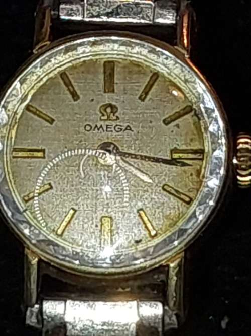 AN ANTIQUE OMEGA WOMANS WATCH SOLD AS IS NOT TESTED