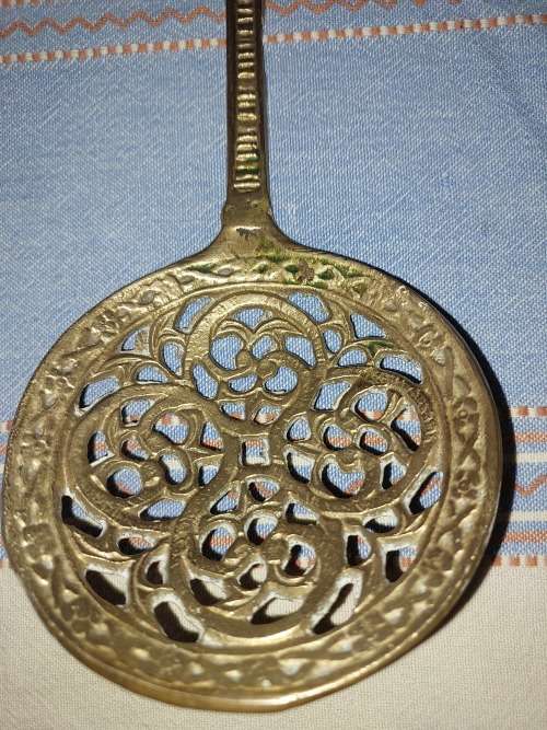 A SET OF ORNAMENTAL BRASS LADEL AND FORK MADE IN ISREAL LENGTH 35 TO 40 CENTIMETERS SOLD AS IS