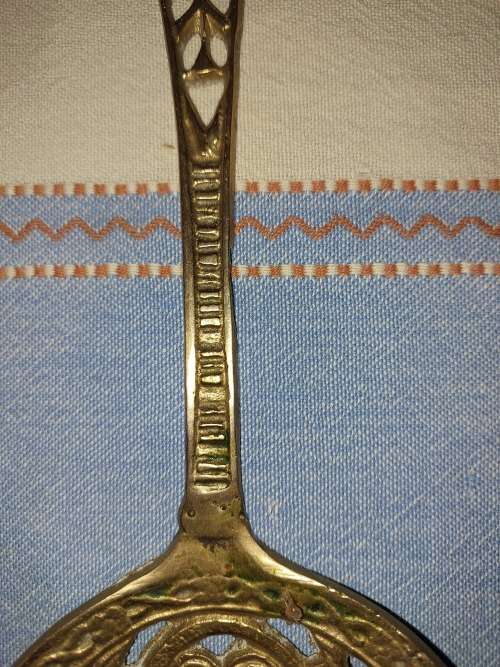 A SET OF ORNAMENTAL BRASS LADEL AND FORK MADE IN ISREAL LENGTH 35 TO 40 CENTIMETERS SOLD AS IS