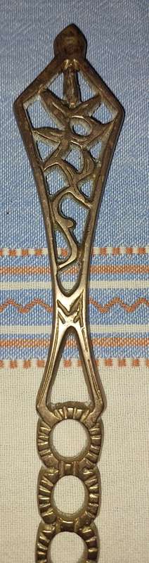 A SET OF ORNAMENTAL BRASS LADEL AND FORK MADE IN ISREAL LENGTH 35 TO 40 CENTIMETERS SOLD AS IS
