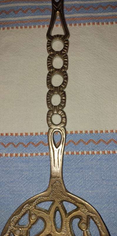 A SET OF ORNAMENTAL BRASS LADEL AND FORK MADE IN ISREAL LENGTH 35 TO 40 CENTIMETERS SOLD AS IS
