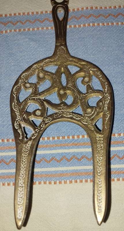 A SET OF ORNAMENTAL BRASS LADEL AND FORK MADE IN ISREAL LENGTH 35 TO 40 CENTIMETERS SOLD AS IS