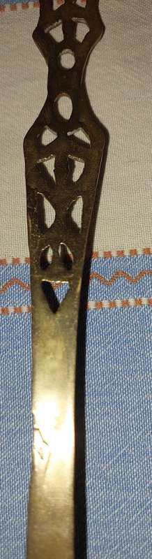 A SET OF ORNAMENTAL BRASS LADEL AND FORK MADE IN ISREAL LENGTH 35 TO 40 CENTIMETERS SOLD AS IS
