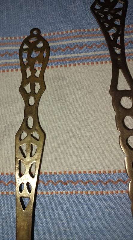 A SET OF ORNAMENTAL BRASS LADEL AND FORK MADE IN ISREAL LENGTH 35 TO 40 CENTIMETERS SOLD AS IS