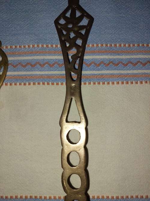 A SET OF ORNAMENTAL BRASS LADEL AND FORK MADE IN ISREAL LENGTH 35 TO 40 CENTIMETERS SOLD AS IS