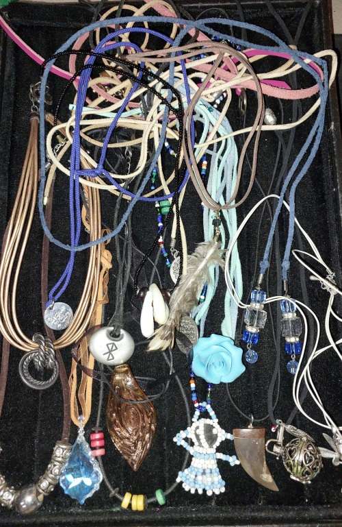 A BULK COLLECTION OF LEATHER ROPE COSTUME NECKLACES SOLD AS IS