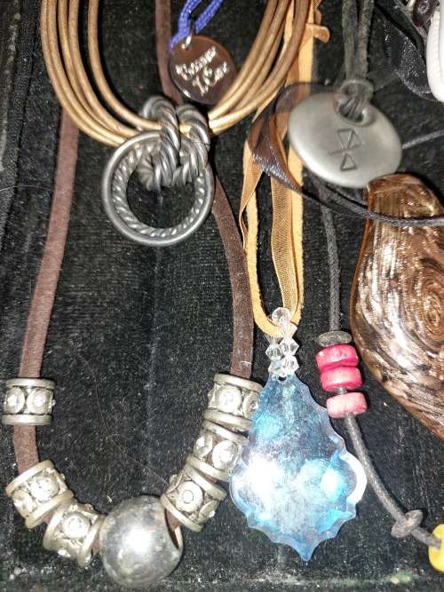 A BULK COLLECTION OF LEATHER ROPE COSTUME NECKLACES SOLD AS IS