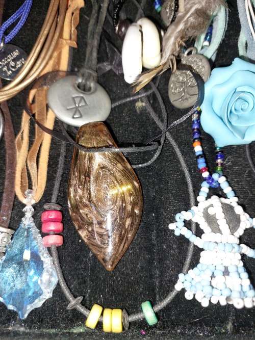 A BULK COLLECTION OF LEATHER ROPE COSTUME NECKLACES SOLD AS IS