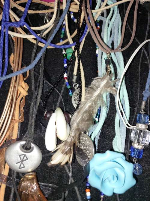 A BULK COLLECTION OF LEATHER ROPE COSTUME NECKLACES SOLD AS IS