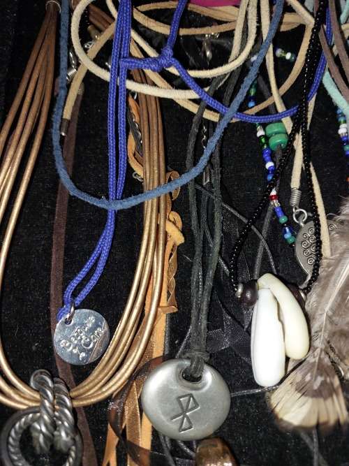 A BULK COLLECTION OF LEATHER ROPE COSTUME NECKLACES SOLD AS IS