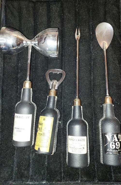 A COLLECTION OF DECORATIVE BAR UTENSILS SOLD AS IS