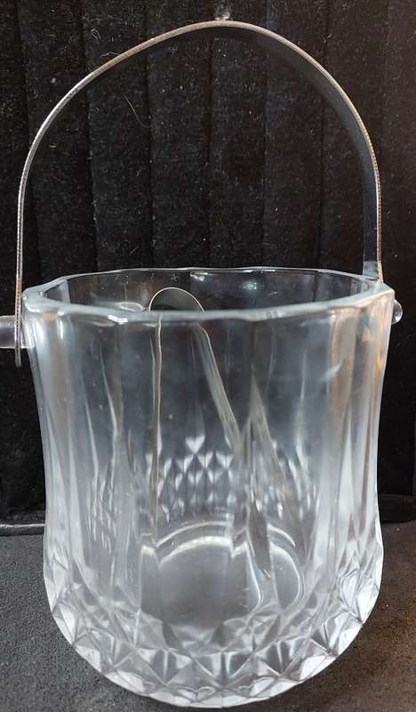 A FANCY CRYSTAL GLASS TYPE ICE BUCKET AND TONGS SOLD AS IS