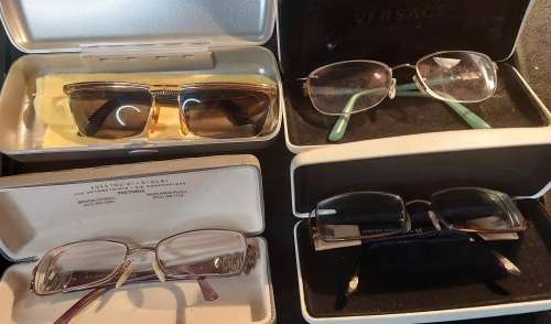 A COLLECTION OF POLICE VERSACE AND BVLGARI SPECTACLES SOLD AS IS