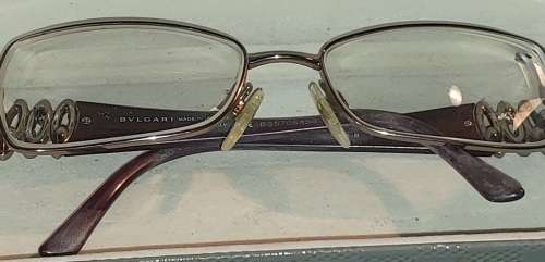 A COLLECTION OF POLICE VERSACE AND BVLGARI SPECTACLES SOLD AS IS