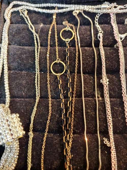 A COLLECTION OF SILVER PLATED AND STAINLESS STEEL NECKLACES WITH PENDANTS SOLD AS IS