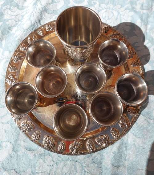A VINTAGE KIDDUSH SET OF CUPS AND SERVING TRAY SOLD AS IS