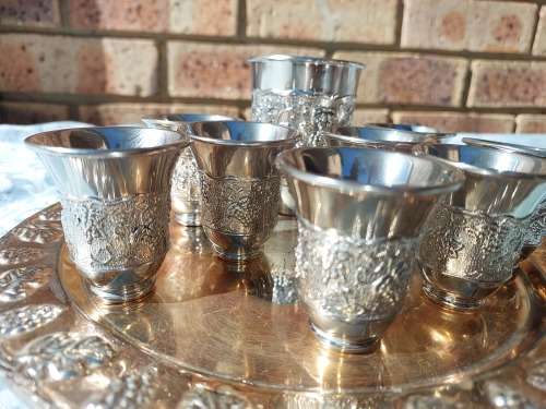 A VINTAGE KIDDUSH SET OF CUPS AND SERVING TRAY SOLD AS IS