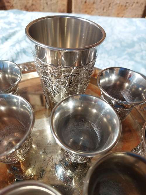 A VINTAGE KIDDUSH SET OF CUPS AND SERVING TRAY SOLD AS IS