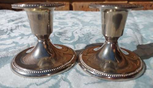 A SET STAINLESS STEEL CANDLE STANDS IN GOOD CONDITION SOLD AS IS