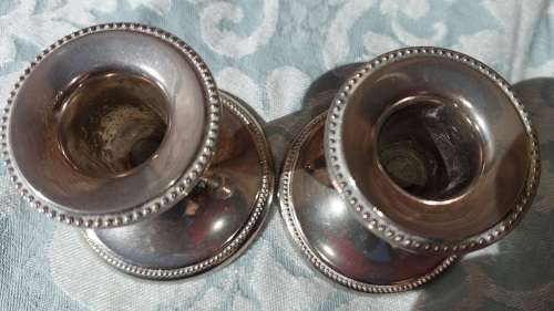 A SET STAINLESS STEEL CANDLE STANDS IN GOOD CONDITION SOLD AS IS