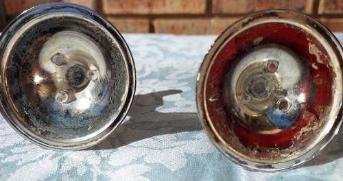 A SET STAINLESS STEEL CANDLE STANDS IN GOOD CONDITION SOLD AS IS