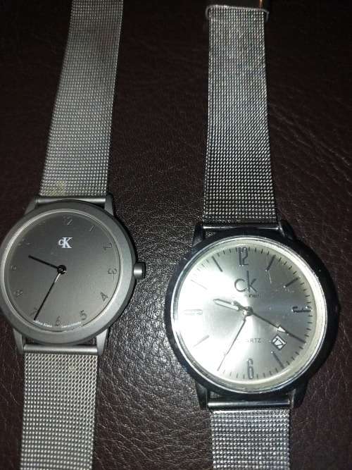TWO CK SILVER PLATED WRIST WATCHES SOLD AS IS NOT TESTED