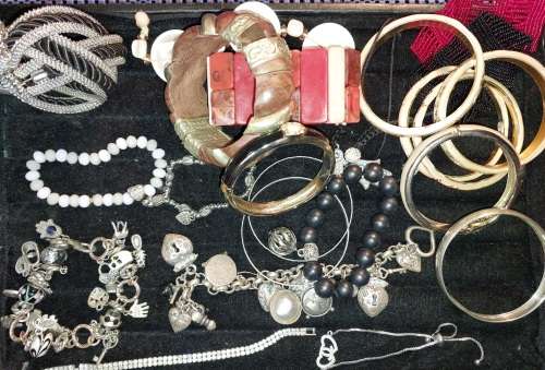 A COLLECTION OF VINTAGE COSTUME BRACELETS AND BANGLES SOLD AS IS