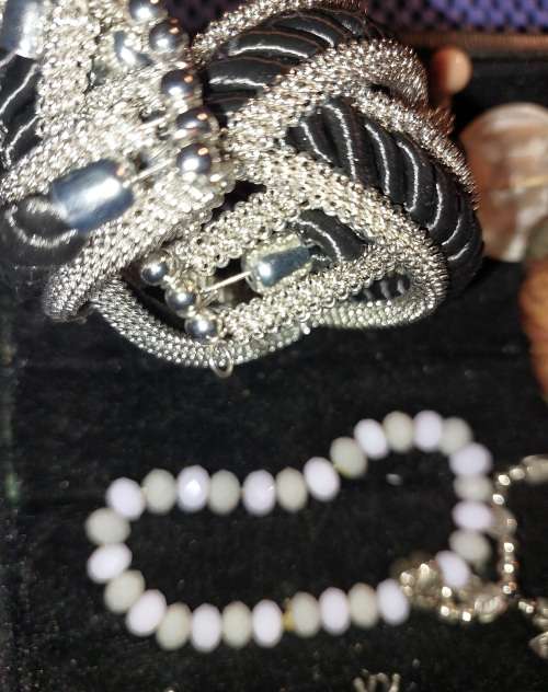 A COLLECTION OF VINTAGE COSTUME BRACELETS AND BANGLES SOLD AS IS