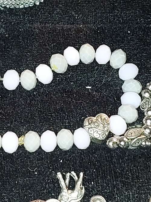 A COLLECTION OF VINTAGE COSTUME BRACELETS AND BANGLES SOLD AS IS
