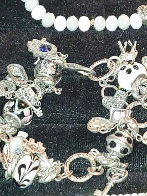 A COLLECTION OF VINTAGE COSTUME BRACELETS AND BANGLES SOLD AS IS
