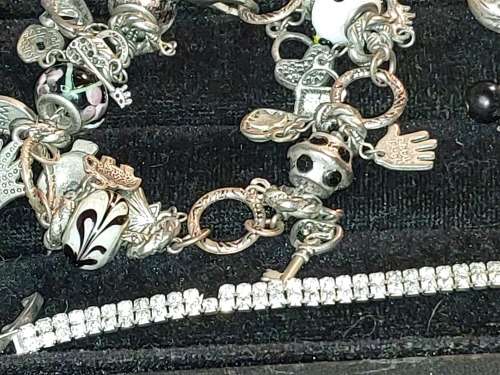 A COLLECTION OF VINTAGE COSTUME BRACELETS AND BANGLES SOLD AS IS