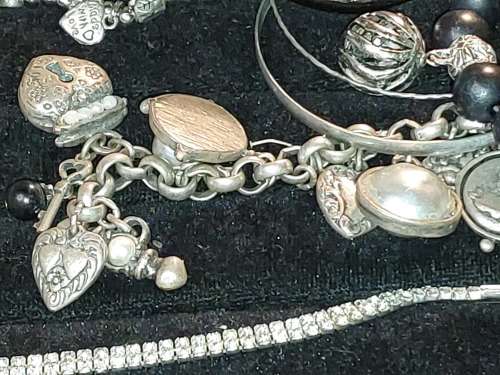 A COLLECTION OF VINTAGE COSTUME BRACELETS AND BANGLES SOLD AS IS