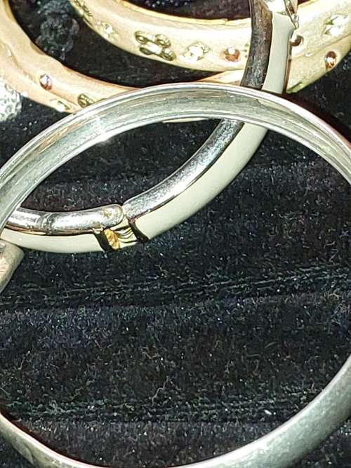 A COLLECTION OF VINTAGE COSTUME BRACELETS AND BANGLES SOLD AS IS