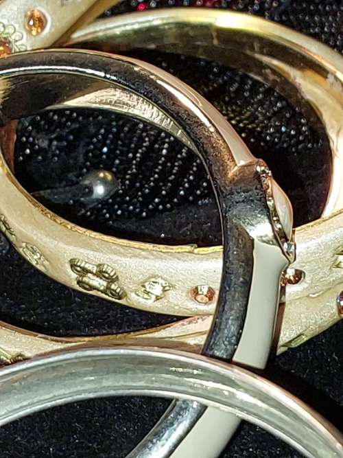 A COLLECTION OF VINTAGE COSTUME BRACELETS AND BANGLES SOLD AS IS