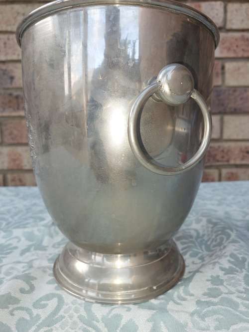 A VINTAGE SILVER PLATED ON BRONZE ICE BUCKET WITH HANDLES