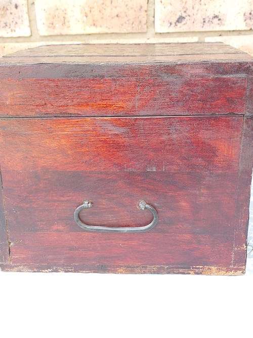 AN ANTIQUE WOODEN CHEST WITH INTRICATE BRONZE WORK