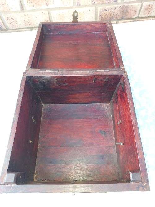 AN ANTIQUE WOODEN CHEST WITH INTRICATE BRONZE WORK
