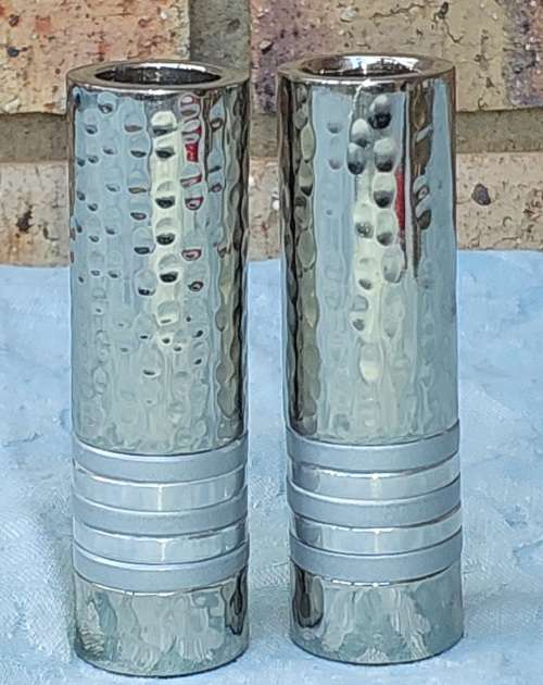 A PAIR OF STAINLESS STEEL ART DECOR CANDLE STANDS SOLD AS IS