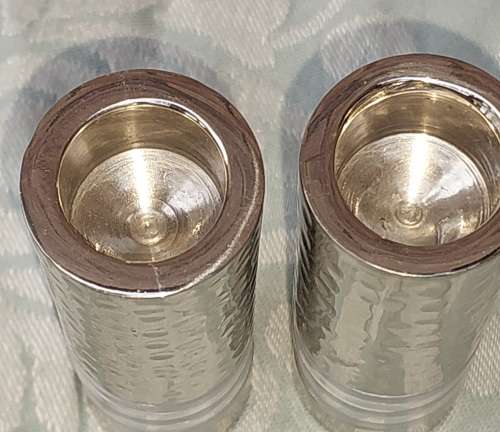 A PAIR OF STAINLESS STEEL ART DECOR CANDLE STANDS SOLD AS IS