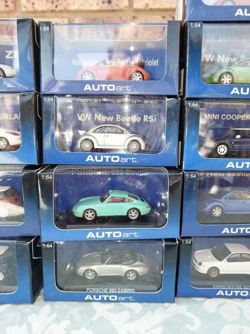 A COLLECTION OF 24 AUTO ART ADULT COLLECTORS EDITION DIECAST CARS IN MINT CONDITION SOLD AS IS