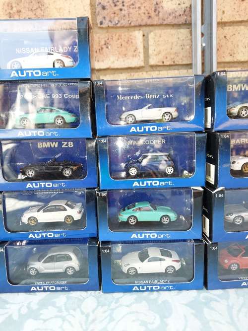 A COLLECTION OF 24 AUTO ART ADULT COLLECTORS EDITION DIECAST CARS IN MINT CONDITION SOLD AS IS