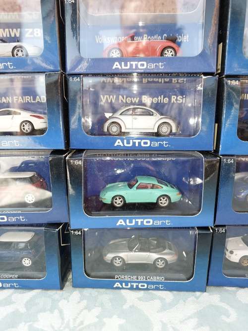 A COLLECTION OF 24 AUTO ART ADULT COLLECTORS EDITION DIECAST CARS IN MINT CONDITION SOLD AS IS