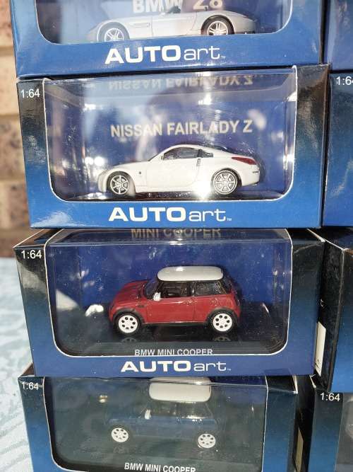A COLLECTION OF 24 AUTO ART ADULT COLLECTORS EDITION DIECAST CARS IN MINT CONDITION SOLD AS IS